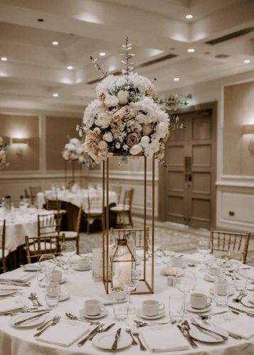 Vintage style floral centerpiece on wedding table by Rosewater Decor